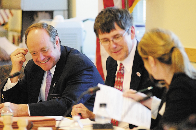 Sen. Andre Cushing, R-Hampden, left, confers with co-chairs Sen. John Patrick, D- Rumford, and Rep. Erin Herbig, D-Belfast, before a work session on L.D. 1230 on Friday in the Cross building in Augusta.