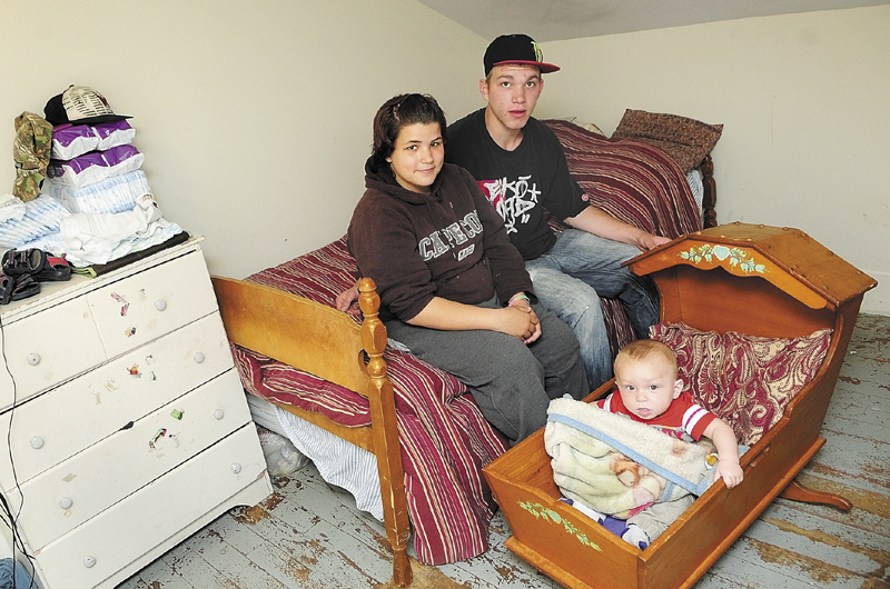 Tatiana Nirza, left, 17, Kristopher Hartford, 19, and their son, Kayden Kristopher Hartford, 7 months, in their room Friday on the third floor of Bread of Life Shelter in Augusta.