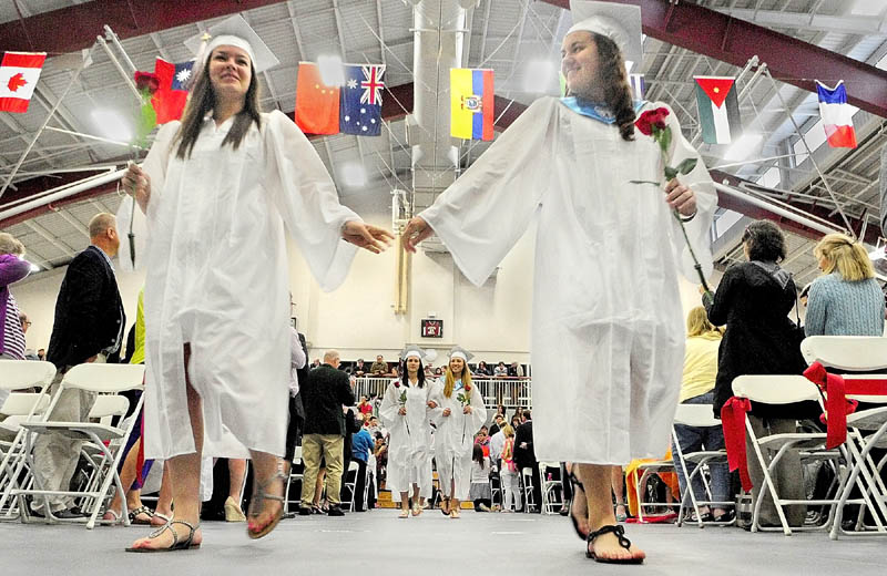 Seniors Asa Gomberg, left, and Savannah Poole march into the Gannett Gym in the Alfond Athletics Center at the start of the Kents Hill School graduation on Saturday in Readfield.
