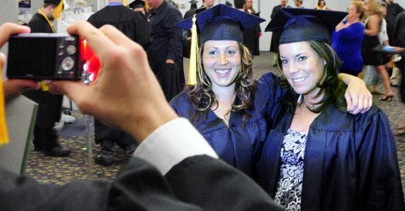 Robin Brady, of Pembroke, left, and Stephanie Escude, of Waterville, poses for a snapshot before the Kennebec Valley Community College commencement on Saturday at the Augusta Civic Center.