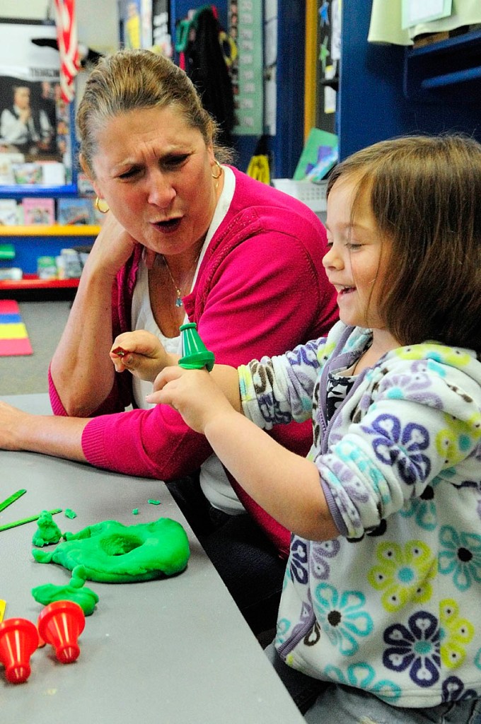 Ed Teck Deb Noyes, left, talks to student Olivia Hall as they play with Play-Doh recently during a pre-kindergarten class at Manchester Elementary School.