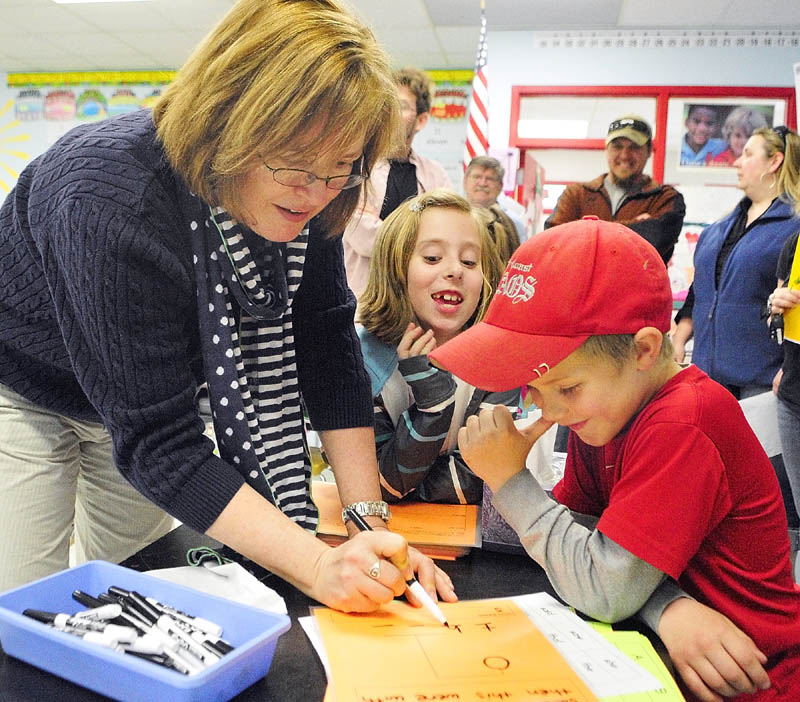 Teacher Kelly Peavey, left, plays a word game with Bella Bodmer, center, and Chase Peaslee during the Education Celebration on Friday at Whitefield Elementary School.