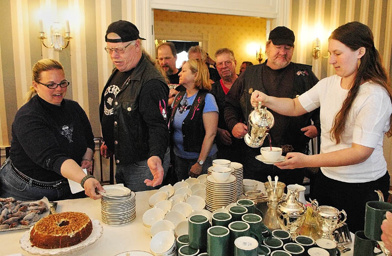 Staffer Kelsey Moody, right, pours tea for motorcyclists on Wednesday at Blaine House in Augusta. The annual United Bikers of Maine Blaine House Tea was kicked off when First Lady Ann LePage arrived as passenger on a motorcycle. There were remarks by her husband Gov. Paul LePage, other state officials and Sonny Bridges, founding father of United Bikers of Maine. There was a proclamation of May as Maine's Motorcycle Safety & Awareness Month.