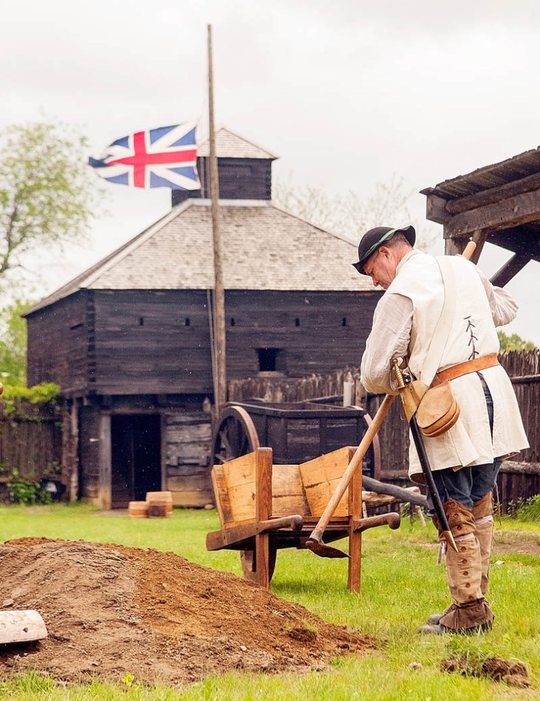 Historical interpreter Pete Morrissey builds a mortar pit at Fort Western on Sunday in Augusta. Morrissey said that the Union Jack was flying at half-staff in honor of Lee Rigby, 25, a drummer in the Royal Regiment of Fusiliers, who was murdered last week in the Woolwich section of London. Morrissey explained that Fort Western was British in the mid-1700s, the time period that they're recreating there, so they wanted to honor Rigby. The city museum opened over the weekend, and is open daily from 1 to 4 p.m. through Sept. 2.