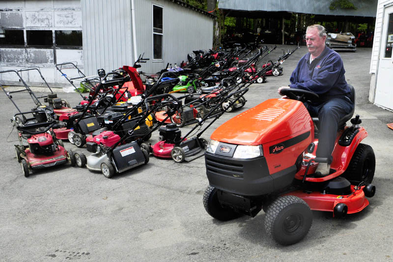 Owner Larry Mason drives a new lawn tractor past rows of push mowers in for repair on Tuesday at Mason's Lawnmower and Power Equipment in Augusta. He said that spring was the busiest time of year, as people bring in mowers, trimmers and tillers in for tune-ups or repairs. Mason said the business was started by his father almost 70 years ago. They repair and sell new and used snowblowers, mowers and other equipment on Haskell Street.