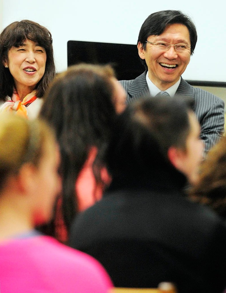 Akira Muto, Japanese Consul General for New England, right, and his wife, Misako, laugh and sing along as Japanese language teacher Naoto Kobayashi leads his students in a song Friday at Richmond Middle School. Muto, who is based in Boston, and his delelgation spent the day visiting Maine. They met with Gov. Paul LePage at the State House in Augusta and stopped at Hall-Dale Elementary School before the Richmond visit. There were visits to Bath and Portland scheduled for later in the day.
