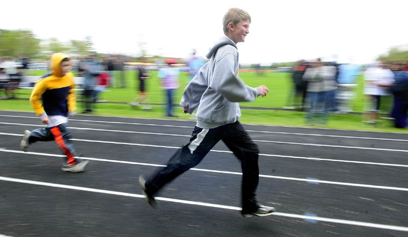 Benjamin Perkins, an independent from Maranacook, center, runs the 100-meter dash during the Kennebec Area Special Olympics Games on Tuesday at Hall-Dale High School in Farmingdale. There were 275 athletes competing in running, jumping and throwing events in the annual meet. About 45 students from Hall-Dale's Jobs For Maine's Graduates program helped to run the event.