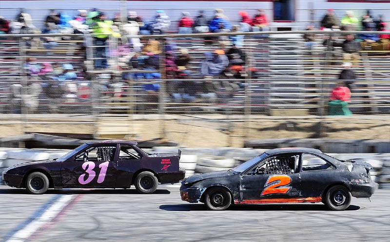 Leandra Martin, left, and Jason Stanley compete in the Thunder Four class feature race on the first day of the 2013 racing season on Saturday April 6, 2013 at Wiscasset Speedway.