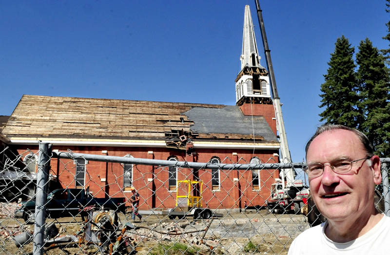 Local historian Bob Chenard on Tuesday, waits with others for workers to remove the steeple from the St. Francis de Sales Catholic Church in Waterville.