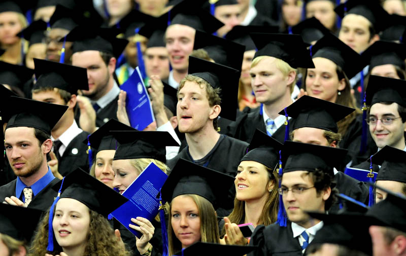 Colby College graduates cheer and whistle during Senior Class speaker Michael Langley's speech during commencement in Waterville on Sunday.