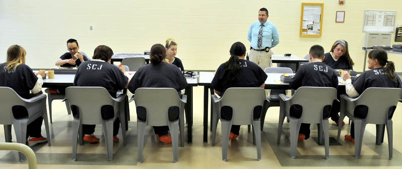 Somerset County Jail Assistant Administrator Maj. Cory Swope speaks with female inmates at the East Madison jail on Tuesday. Somerset County officials filed a civil action case against the state Board of Corrections for $280,000 in funds the state has withheld in an ongoing dispute with the county.