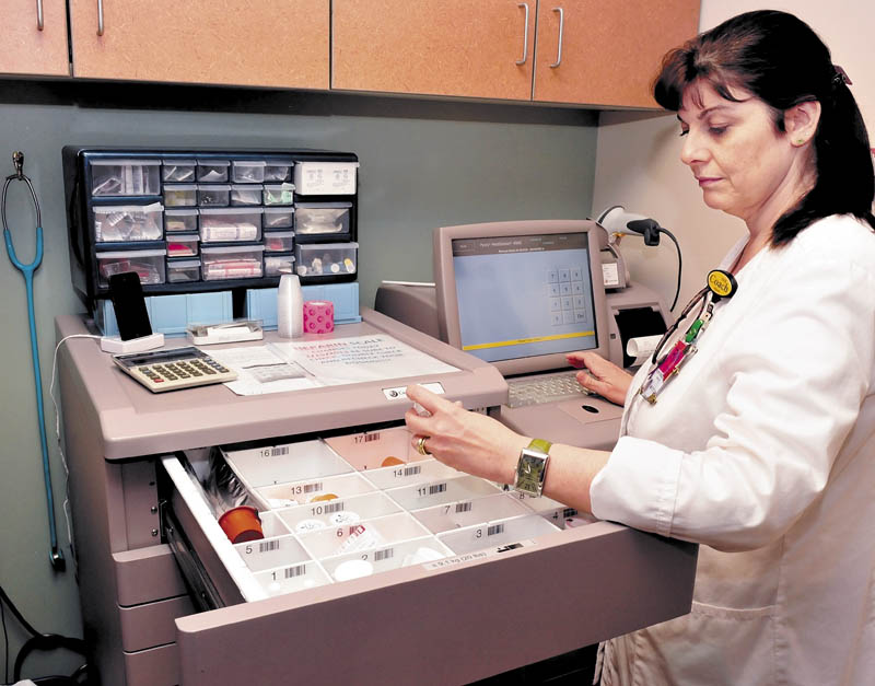 Inland Hospital nurse Hope Pendexter uses a Computerized Provider Order Entry system that ensures that physician prescribed medications, ordered through a computer system, gets to the correct patient at the Waterville hospital on Wednesday.