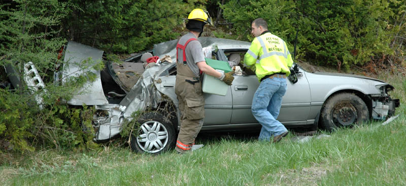 Members of the Pittsfield Fire Department recover items thrown from a 2000 Toyota that crashed and rolled over Thursday afternoon in the northbound lane of Interstate 95 in Pittsfield. Two people from New York were taken to a local hospital, according to state police.