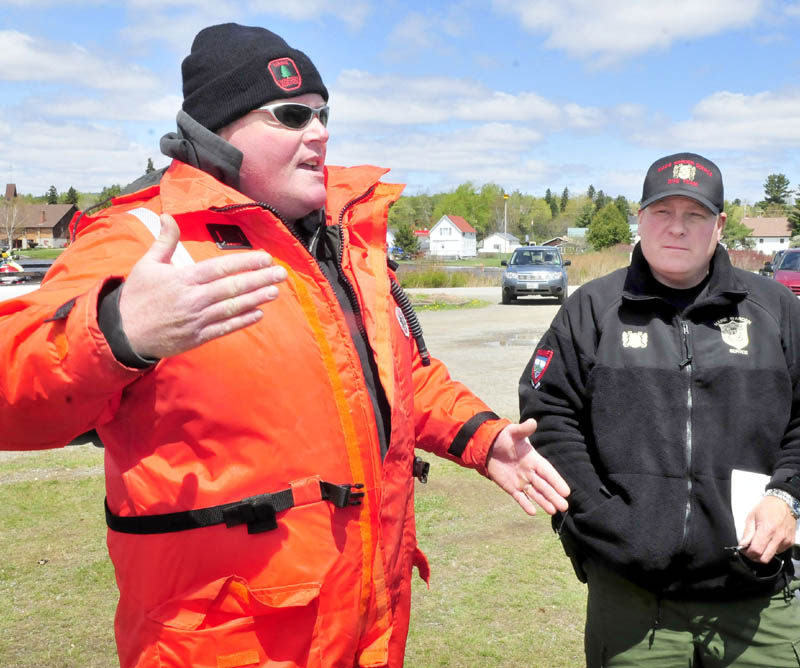 Maine Warden Service dive team leader Mike Joy, left, and Sgt. Scott Thrasher talk about the search for two snowmobilers's bodies in Rangeley Lake on Tuesday. Joy said the team's sonar search was hampered by choppy water conditions.