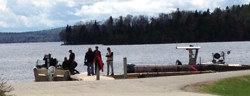 Maine Warden Service divers searched Rangeley Lake on Thursday for three snowmobilers missing since winter.