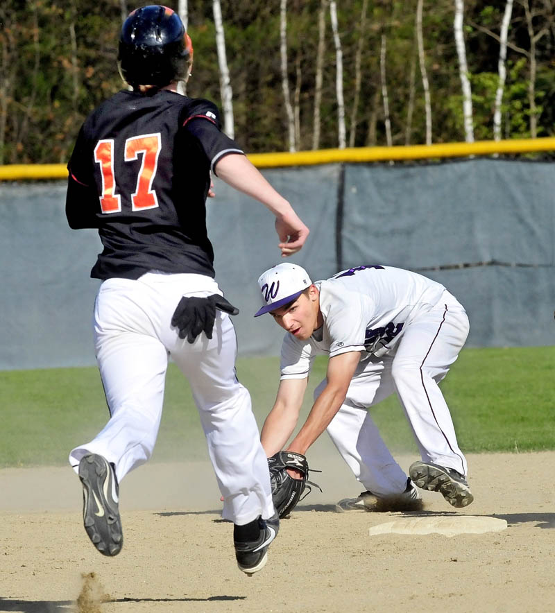 THAT’S AN OUT: Waterville’s Tyler Bouchard scoops the ball and tags second base to force out Winslow’s Alex Berard on Monday in Winslow.