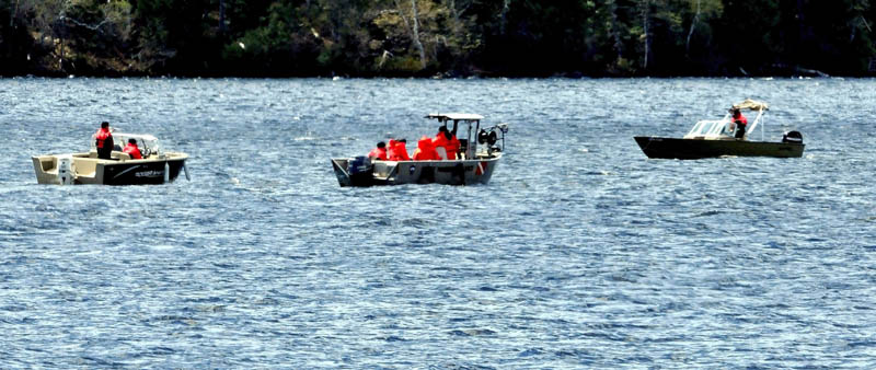 Maine Warden Service boats and personnel drag sonar equipment from the center boat on Tuesday, while doing a grid search of the bottom of Rangeley Lake for the bodies of two snowmobile operators, who went through the ice last Decermber.