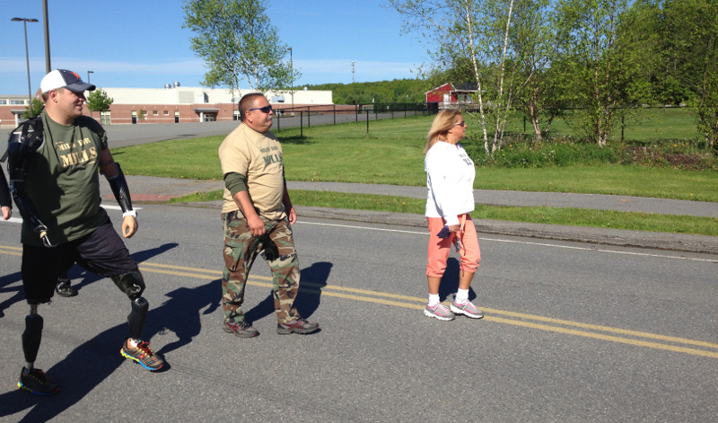 Staff Sgt. Travis Mills, left, walks during the second annual Miles for Mills 5K fundraiser on Monday, in Augusta.