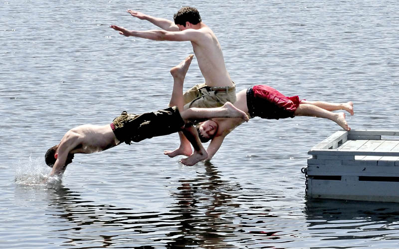 The sun and warmth on Sunday Jake Church, left, Max Pacholski and Conner Paine allowed to jump in and cool off in China Lake in China They all reported the water felt great.