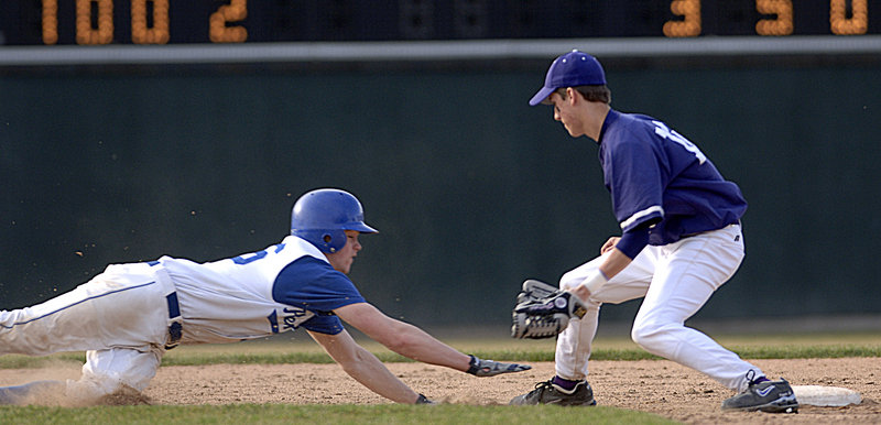 In high school action at Hadlock Field in 2007, James Nutter dives for second as short stop Matt Powers catches a pickoff throw.