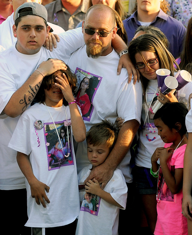 The family of 8-year-old Leila Fowler attends a vigil for her April 30 in Valley Springs, Calif. Her father, Barney Fowler, center, stands with her stepmother, Crystal Walters, right.