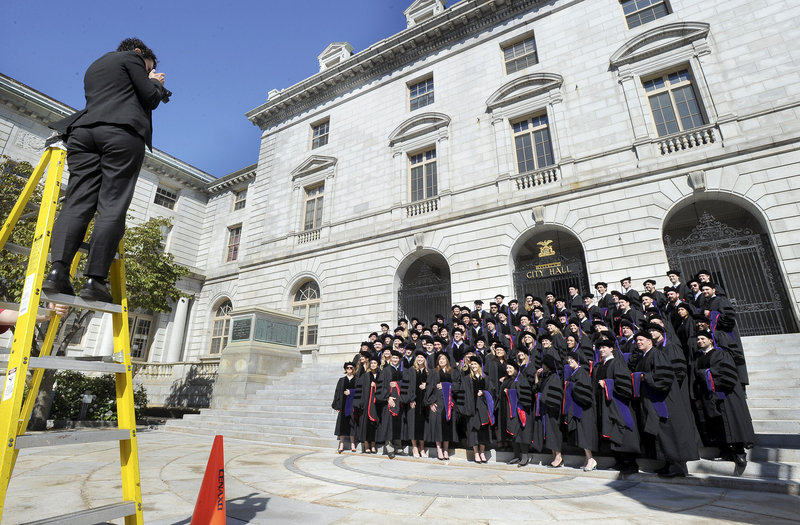 Lana Citowsky takes a photo of University of Maine School of Law graduates in Portland on Saturday.