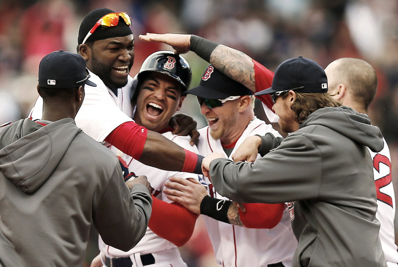 Jacoby Ellsbury is mobbed by teammates after his game-winning two-run double with two outs and the bases loaded in the ninth inning. Boston scored four runs in the ninth to beat Cleveland 6-5.