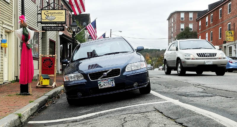 Some of the parking spots on the Kennebec River side of Water Street in downtown Hallowell tilt down toward the sidewalk. Local and state officials on Wednesday will discuss the early findings of a Water Street reconstruction feasibility study, and are expected to answer questions.