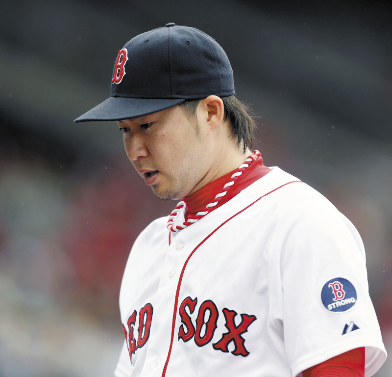 TOUGH DAY: Boston’s Junichi Tazawa walks off the field after the top of the ninth inning of the Red Sox’ game against the Toronto Blue Jays on Saturday in Boston. Tazawa gave up a home run in the ninth and the Sox lost 3-2.