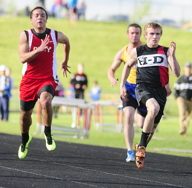 OFF TO THE RACES: Cony's Luke Dang, left, and Hall-Dale's Tyler Fitzgerald run the 100-meter dash during the Cony Under the Lights meet on Friday in Augusta.