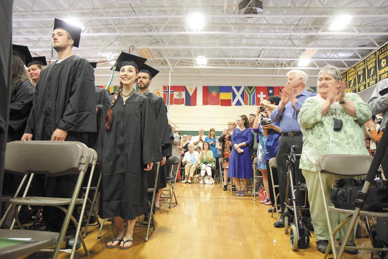 Unity College senior Angelica Morrison, 21, of Smithfield, R.I., smiles while she fellow soon-to-be graduates get a standing ovation at the start of the 44th commencement exercises on Saturday in Unity.