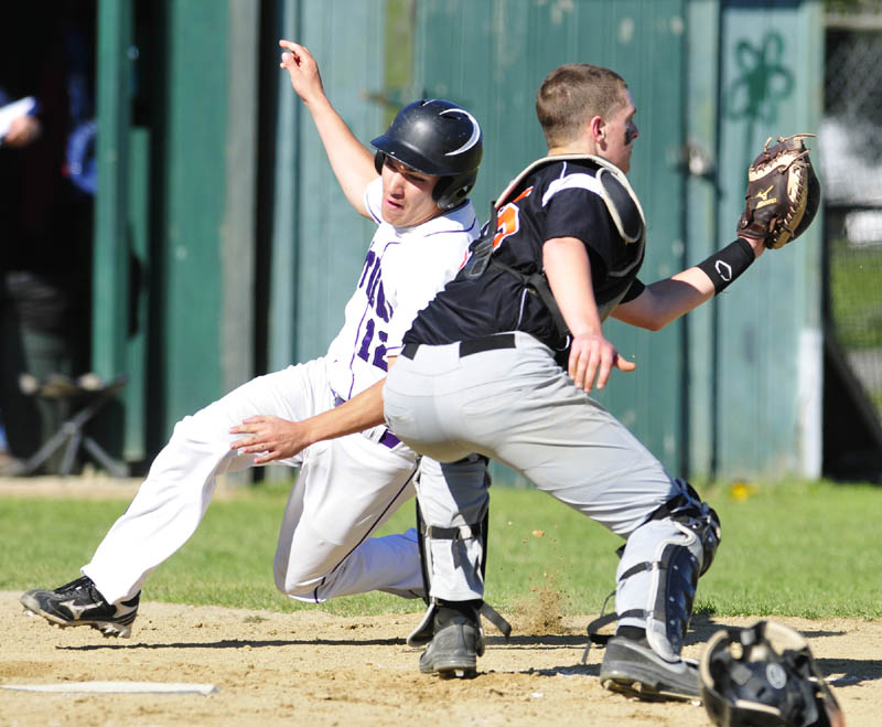 EXCUSE ME: Waterville Tyler Bouchard, left, gets around Gardiner catcher Jensen Orewiler during a game on Friday in Gardiner. He scored on a double by Aiden FitzGerald. Waterville won the game 12-1.