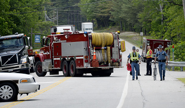 State police move the bike that was involved in a fatal crash in Hanover on Friday.