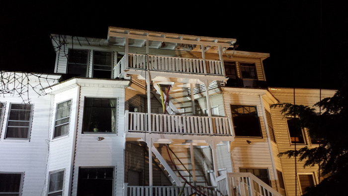 Hoses extend up the staircase to the rear apartments at 26 Sewall St. in Augusta late Saturday. Fire appeared to have damaged the top-floor apartment at the rear of the building. A cause was not immediately available, and it was unknown late Saturday if the fire caused any injuries.