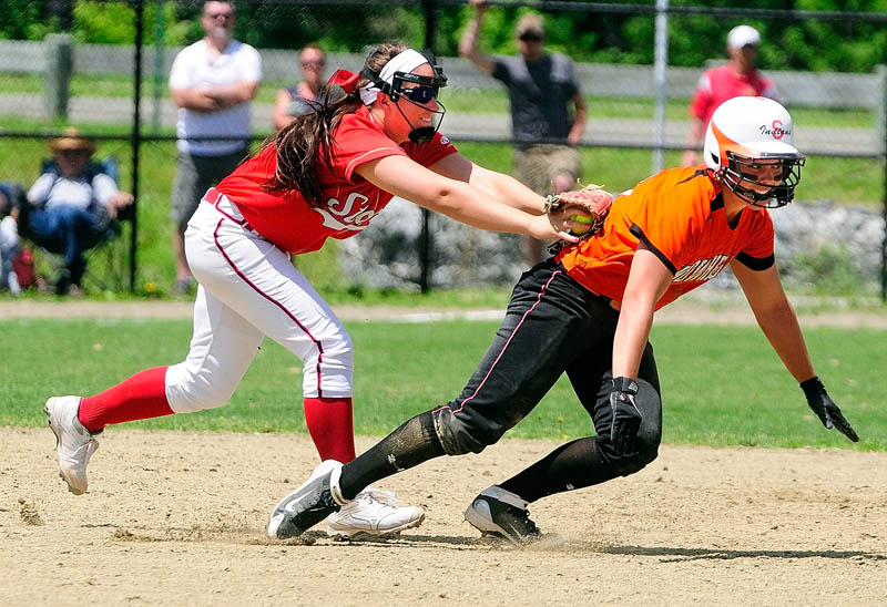 Scarborough third baseman Erin Giles, left, tags out Skowhegan baserunner Shelly Obert after she got caught in rundown between third and second during Class A softball state championship Saturday at Cony Family Field in Augusta.