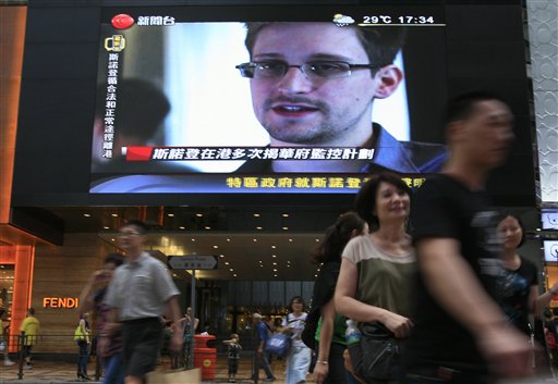 A TV screen shows a news report of Edward Snowden, a former CIA employee who leaked top-secret documents about sweeping U.S. surveillance programs, at a shopping mall in Hong Kong Sunday, June 23, 2013. The U.S. assumes NSA leaker Edward Snowden remains in Russia, and officials are working to have him returned to America to face criminal charges. (AP Photo/Vincent Yu)