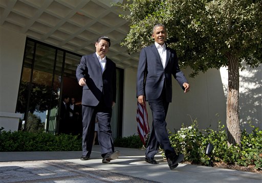 President Barack Obama walks with Chinese President Xi Jinping at the Annenberg Retreat at Sunnylands as they meet for talks Friday in Rancho Mirage, Calif. Seeking a fresh start to a complex relationship, the two leaders are retreating to the sprawling desert estate for two days of talks on high-stakes issues, including cybersecurity and North Korea's nuclear threats.
