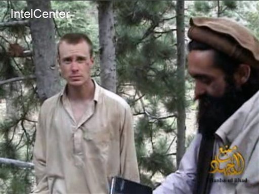 This image provided by IntelCenter shows a frame grab from a video released by the Taliban containing footage of a man believed to be Bowe Bergdahl, left. A Taliban spokesman, Shaheen Suhail, in a telephone interview from the newly opened Taliban offices in Doha, Qatar, said Thursday, that they are ready to hand over Bergdahl for five of their senior operatives being held at the Guantanamo Bay prison.