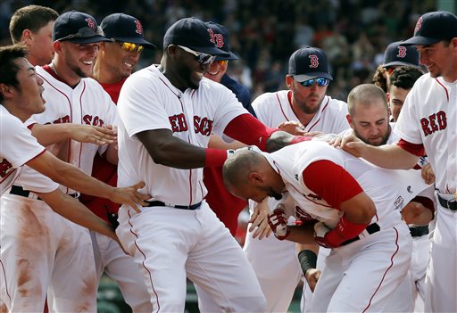 Teammates celebrate with Boston Red Sox outfielder Shane Victorino after reaching on a fielding error by Toronto Blue Jays first baseman Josh Thole, allowing Jonathan Diaz to score in the ninth inning Sunday at Fenway Park in Boston. The Red Sox won 5-4.