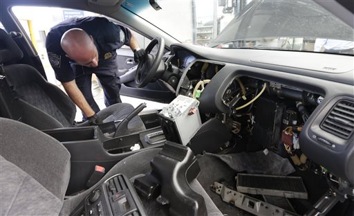 Customs and Border Protection officer Steve Delgado looks in at the dismembered dashboard of a Honda Accord after finding more than 14 pounds of methamphetamine hidden behind the radio at the San Ysidro port of entry on Thursday in San Diego.