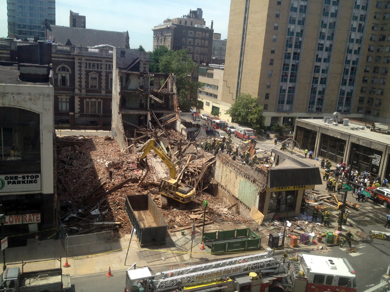 Emergency personnel respond to a building collapse in downtown Philadelphia on Wednesday, where the city fire commissioner said as many as eight to 10 people are believed trapped in the rubble.