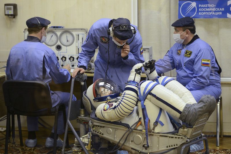 In this picture taken through a safety glass, U.S. astronaut Christopher Cassidy of York, Maine, crew member of the mission to the International Space Station (ISS), is seen during inspection of his space suit prior to the launch of Soyuz-FG rocket at the Russian leased Baikonur Cosmodrome in Kazakhstan on Thursday, March 28, 2013. (AP Photo/Ramil Sitdikov, Pool)