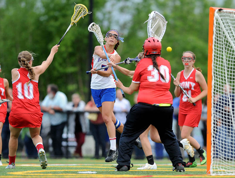 Messalonskee High School's Kristyna Bernatchez, 7, center, takes a shot on Cony High School goalie Isabelle Eames, 30, in the second half of the Eastern A semifinals game at Thomas College in Waterville on Saturday. Cony defeated Messalonskee 13-10.