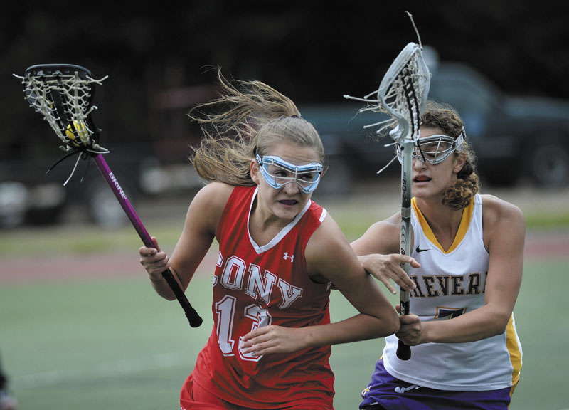 ON THE MOVE: Cony’s Hayley Quirion takes off down field as Elyse Caiazzo of Cheverus moves in on defense during the Stags’ 16-6 win in the Eastern Maine Class A regional final Wednesday at Fitzpatrick Stadium in Portland.