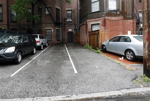 Parking spaces behind 298 Commonwealth Ave. in Boston are seen Friday. The two open spaces at right, front and back, were sold at auction on Thursday for $560,000.