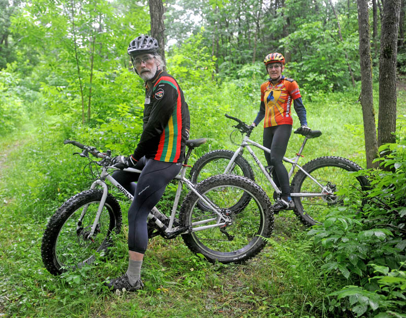 Laurie and Glenn Fenlason, of Winslow, take a ride on one of their many mountain bike trails on their property, known as The Playground.
