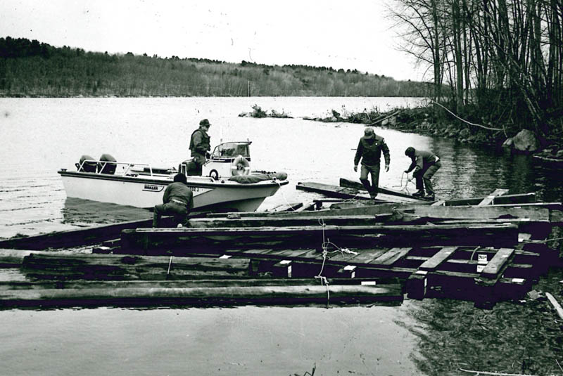 Workers recover timbers of the Fort Halifax blockhouse from the Kennebec River, in the weeks after a 1987 flood destroyed the historic building.