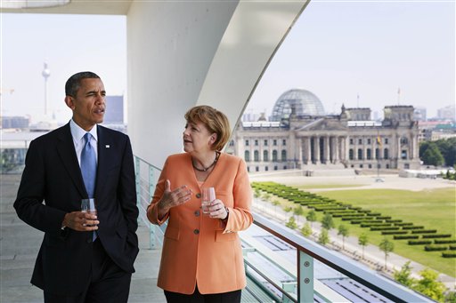 In this photo provided by the German government's press office, German Chancellor Angela Merkel talks to President Barack Obama at the chancellery in Berlin on Wednesday. In the background is the German Parliament building, the Reichstag.