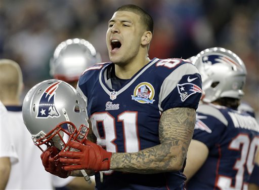 New England Patriots tight end Aaron Hernandez reacts during the second quarter of an NFL football game against the Houston Texans in Foxborough, Mass. in December 2012. State and local police spent hours at the home of New England Patriots tight end Aaron Hernandez on Tuesday as another group of officers searched an industrial park about a mile away where a body was discovered the day before.
