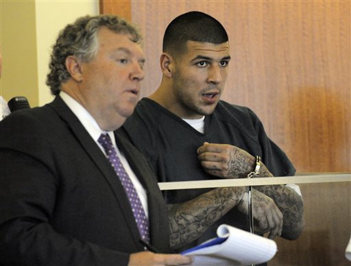 Former New England Patriots football player Aaron Hernandez, right, stands with his attorney Michael Fee, during a bail hearing in Fall River Superior Court on Thursday in Fall River, Mass. Hernandez, charged with murdering Odin Lloyd, a 27-year-old semi-pro football player, was denied bail.